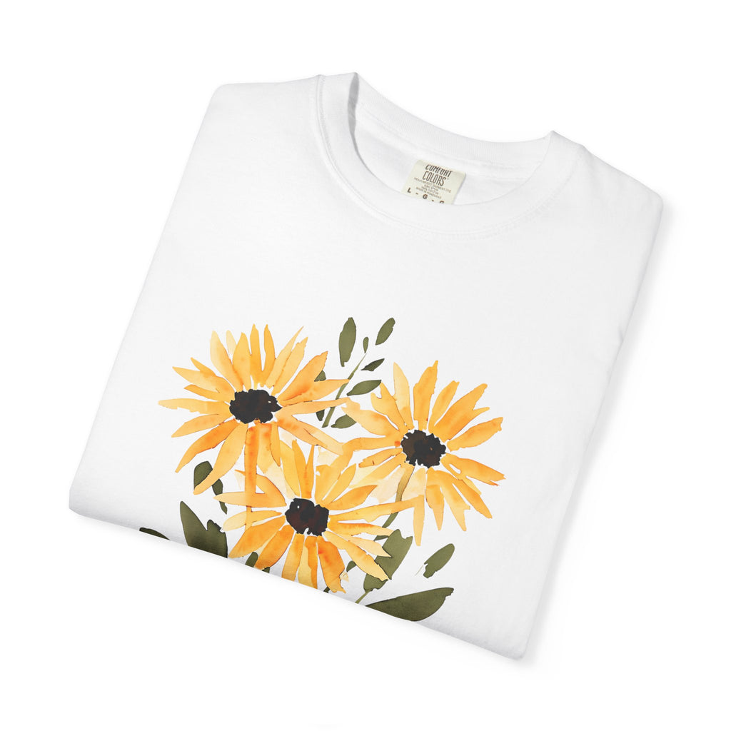 White t-shirt, folded view with sunflower bouquet graphic in orange, yellow, and dark