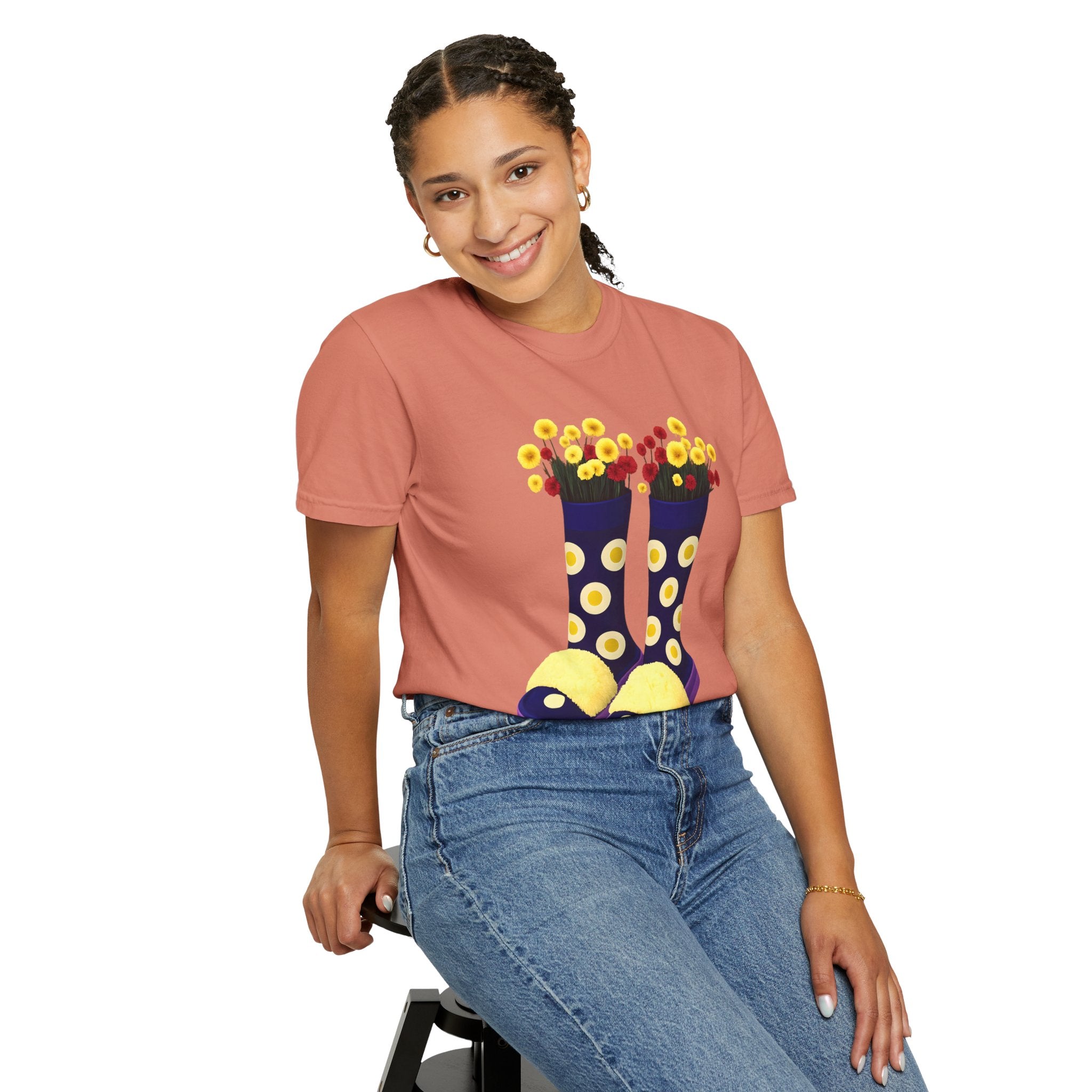 Terracotta t-shirt with floral rain boot graphic in yellow, white, and purple.