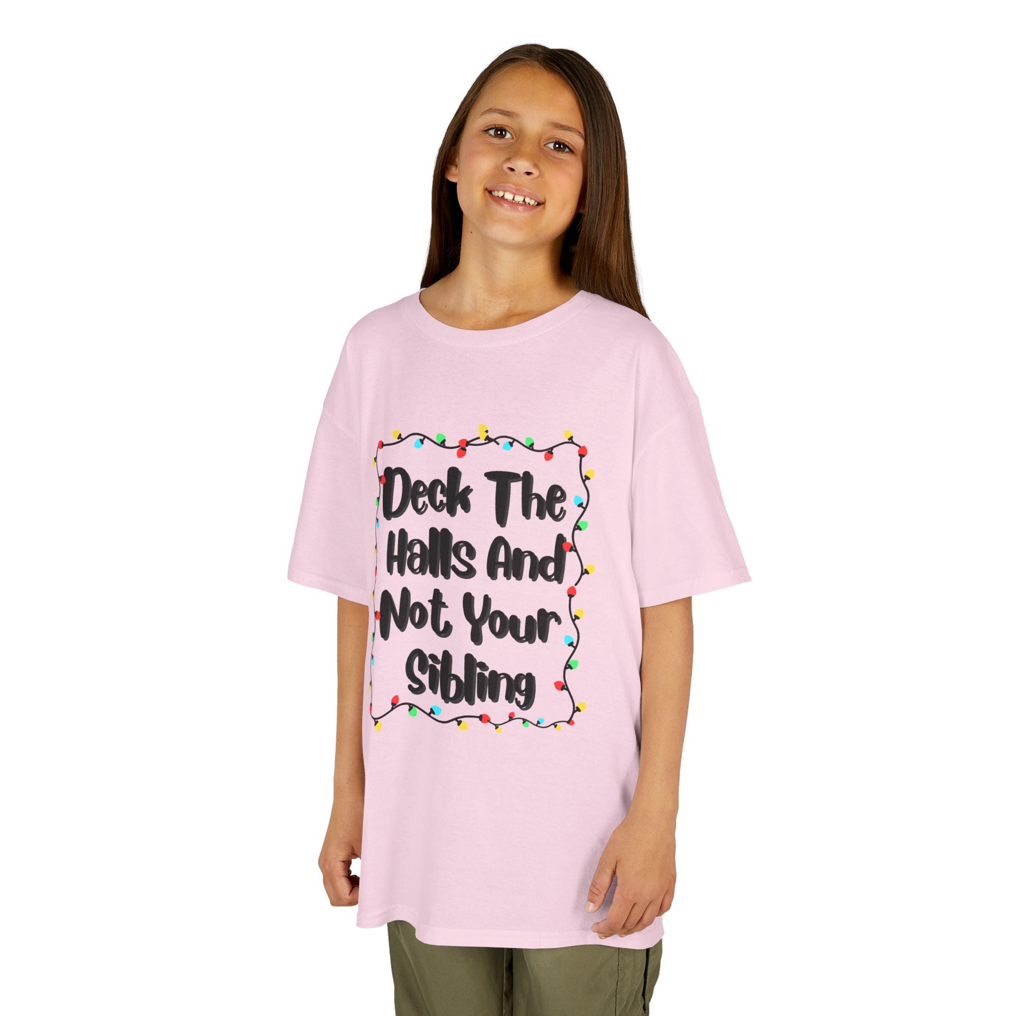 Light pink kids graphic tee on child, colorful holiday lights slogan design