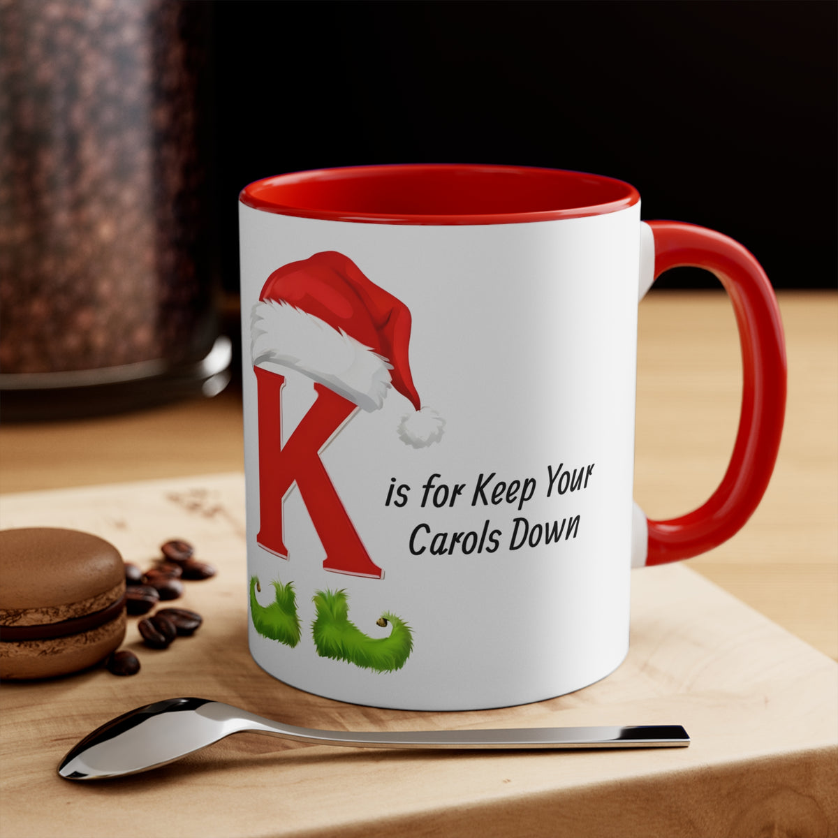 Ceramic mug with red handle and inside rim, white body, K with Santa hat holiday design.