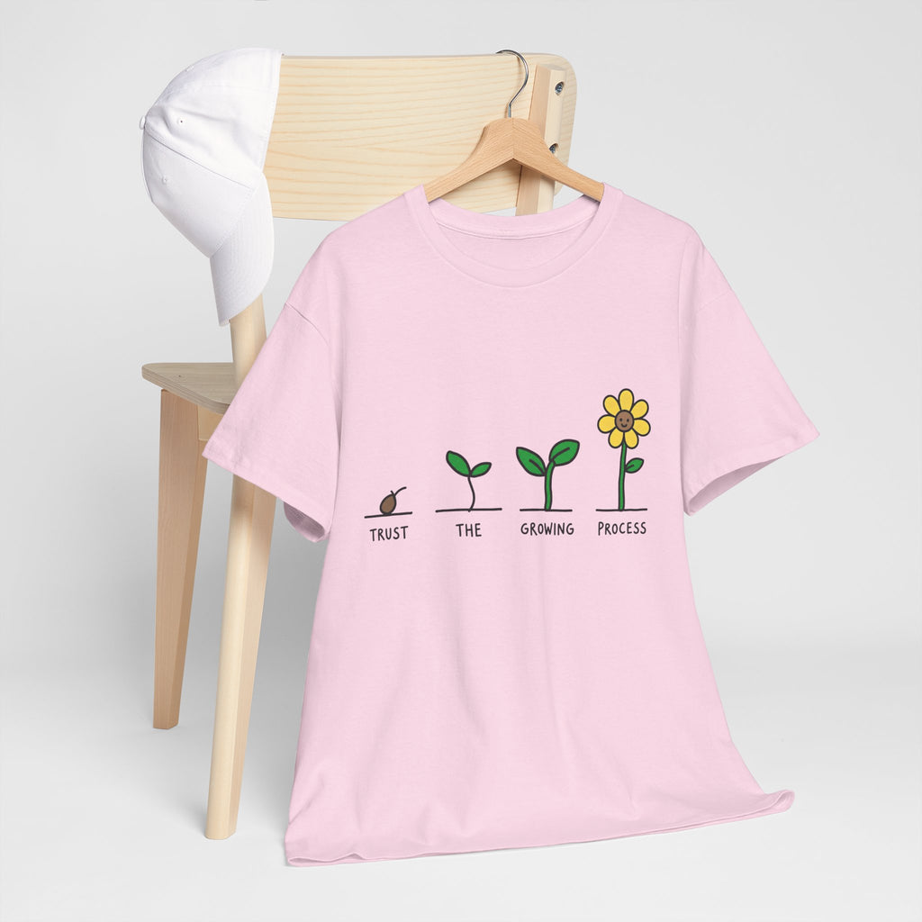 Pink crewneck T-shirt with seedling-to-flower graphic and small slogan text