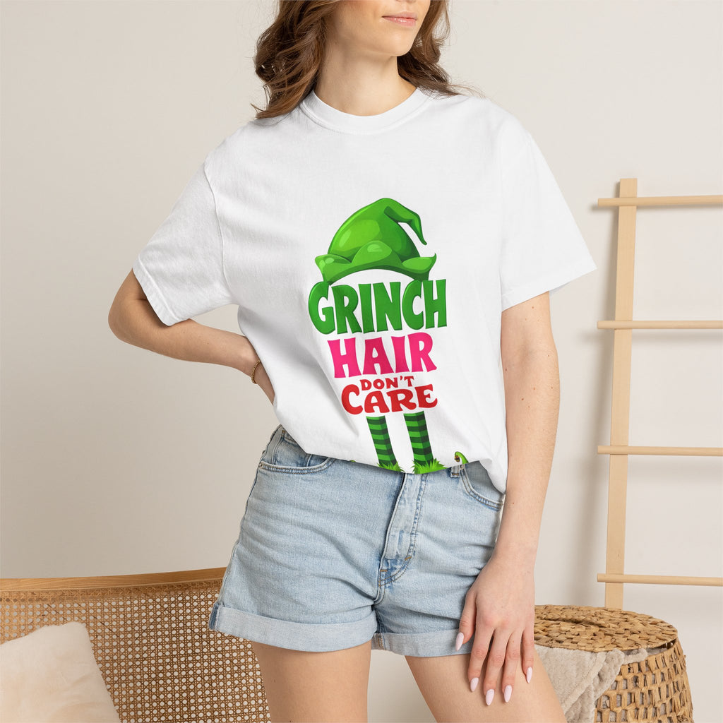 White graphic t-shirt worn by model with green “Hair Don’t Care” character print