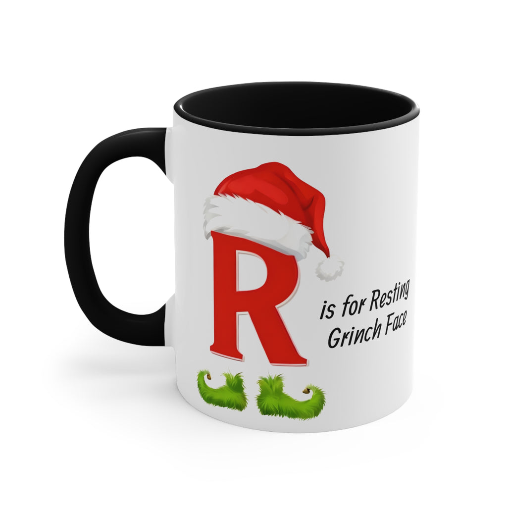 White mug with black handle and dark interior, red letter R and Grinch face graphic