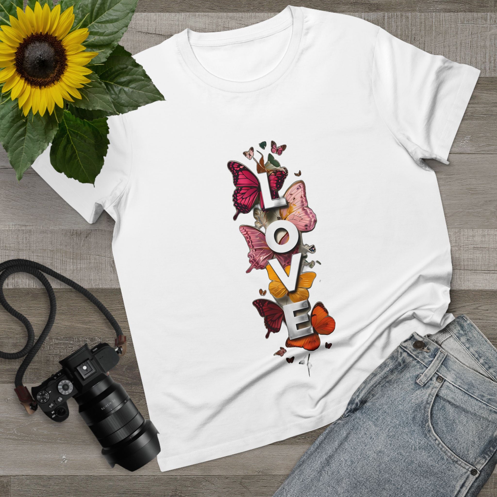 White women's graphic tee with centered LOVE letters and butterfly artwork.