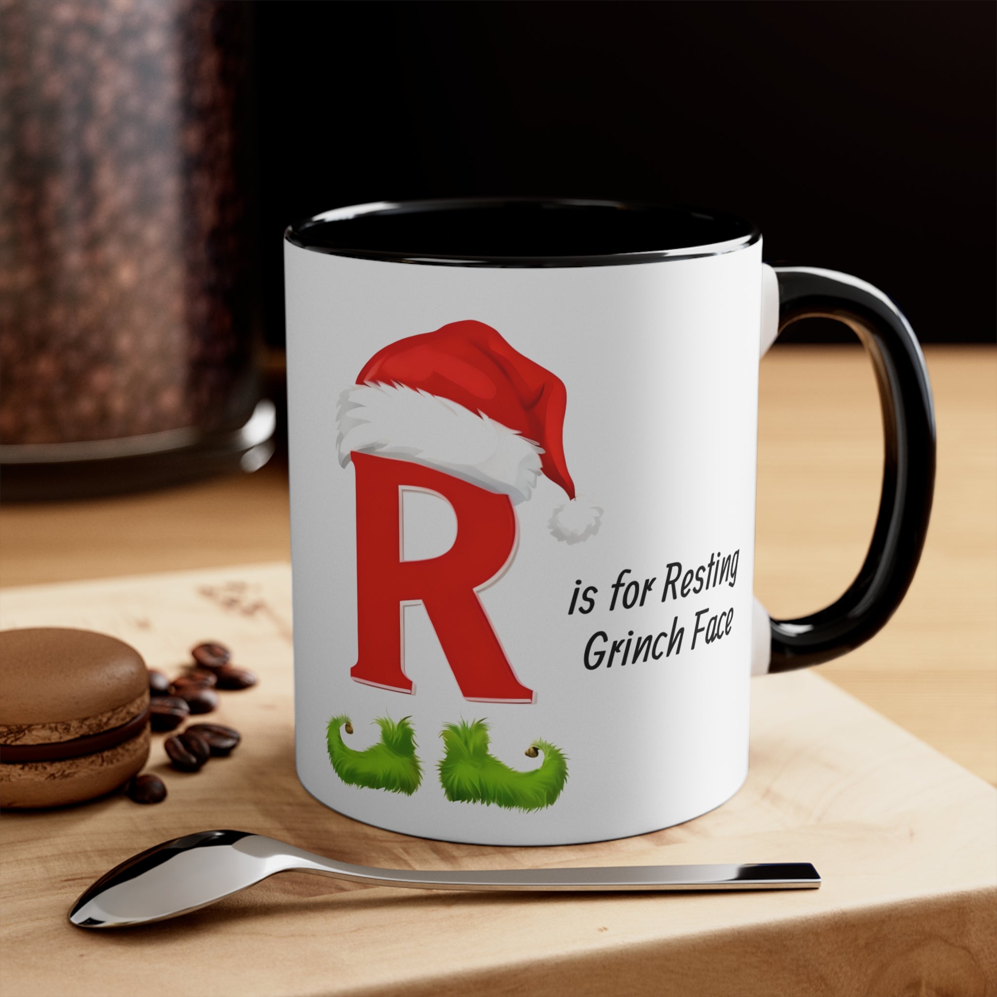 Black-handled white mug with letter R and resting Grinch face holiday graphic