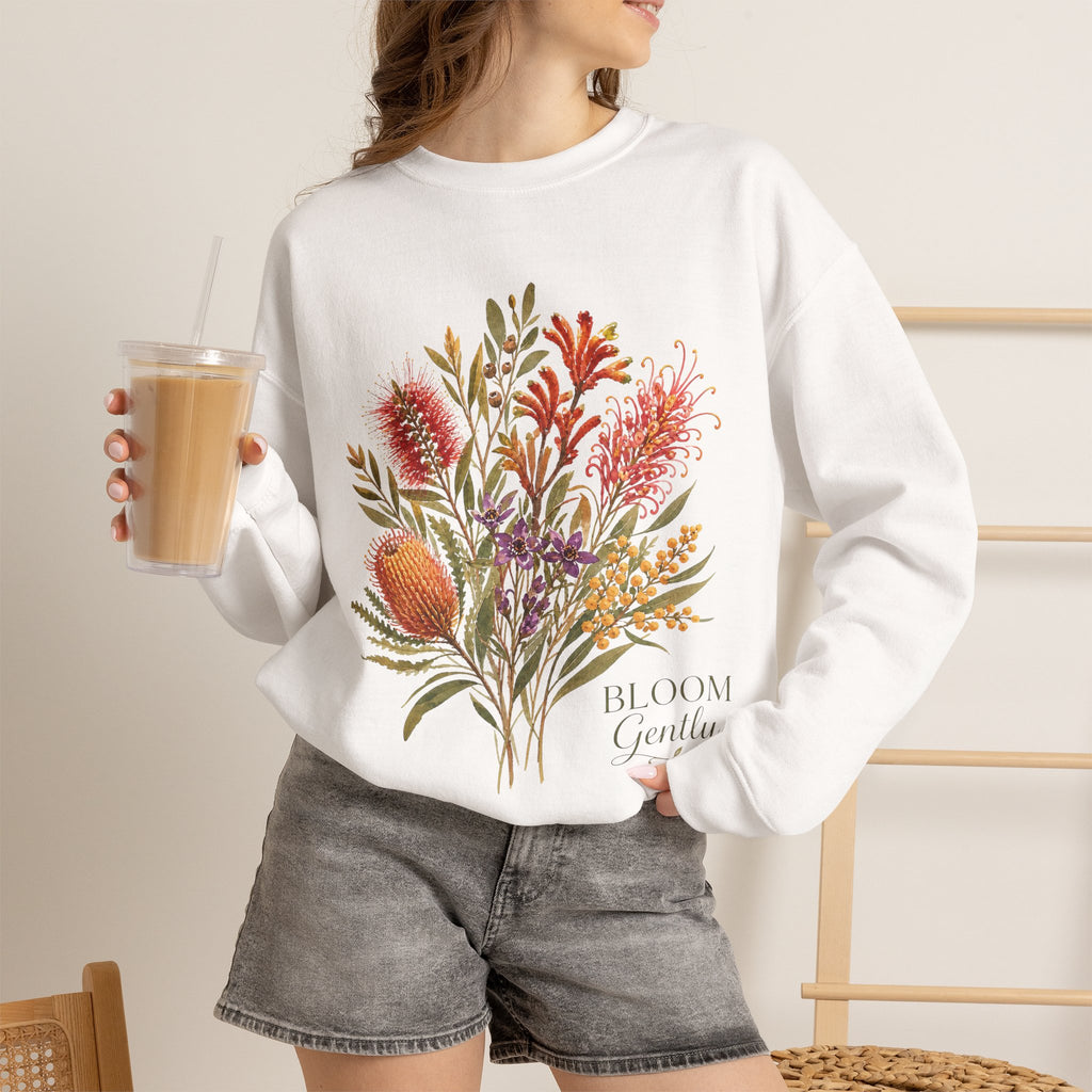 White crewneck sweatshirt on model, colorful floral bouquet graphic on the chest.