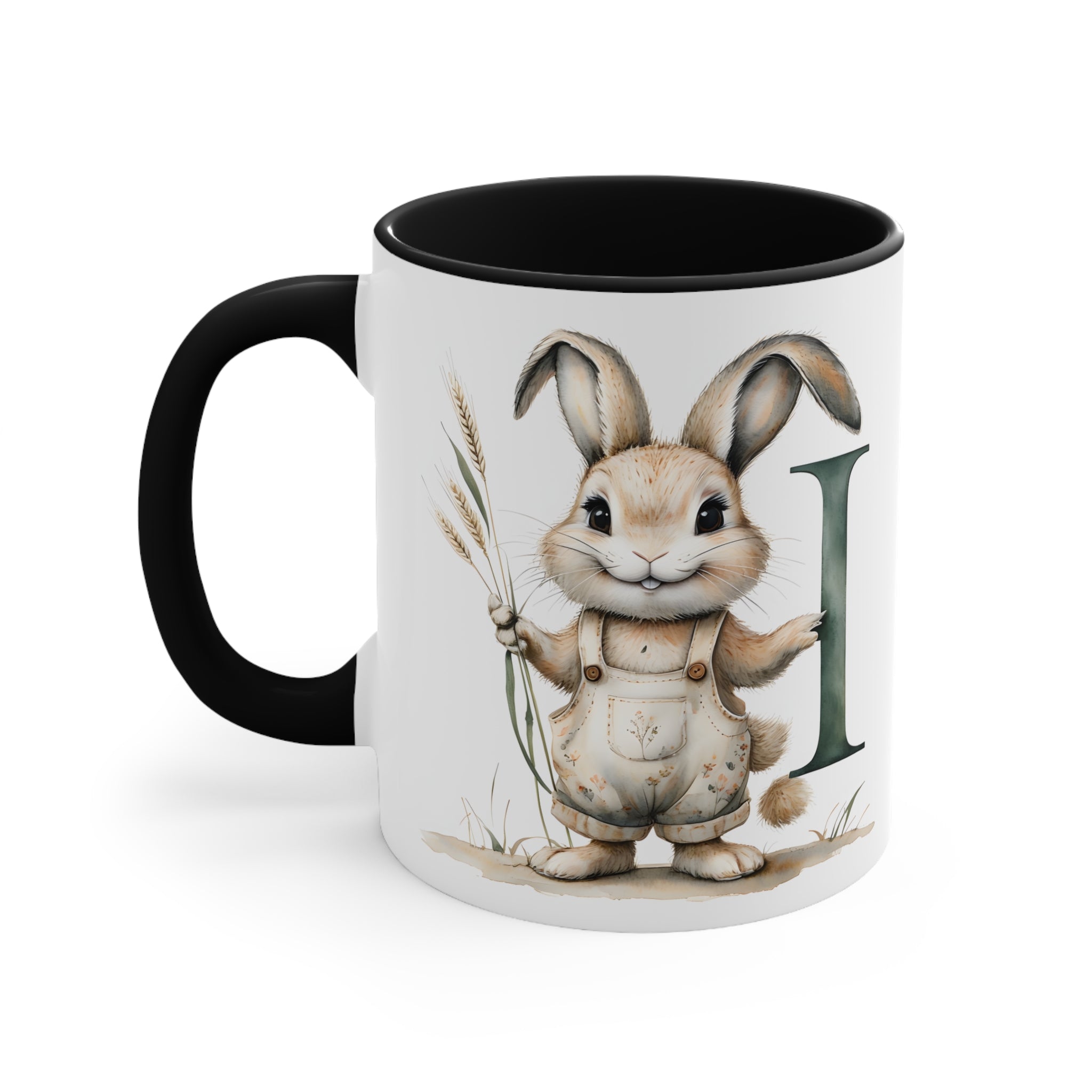 White ceramic mug, black interior, bunny holding a plant beside letter I