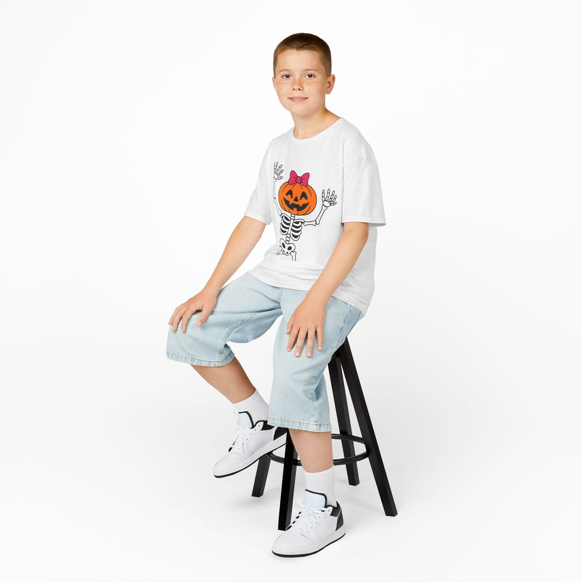White kids Halloween skeleton pumpkin graphic T-shirt, worn by child, crew neck