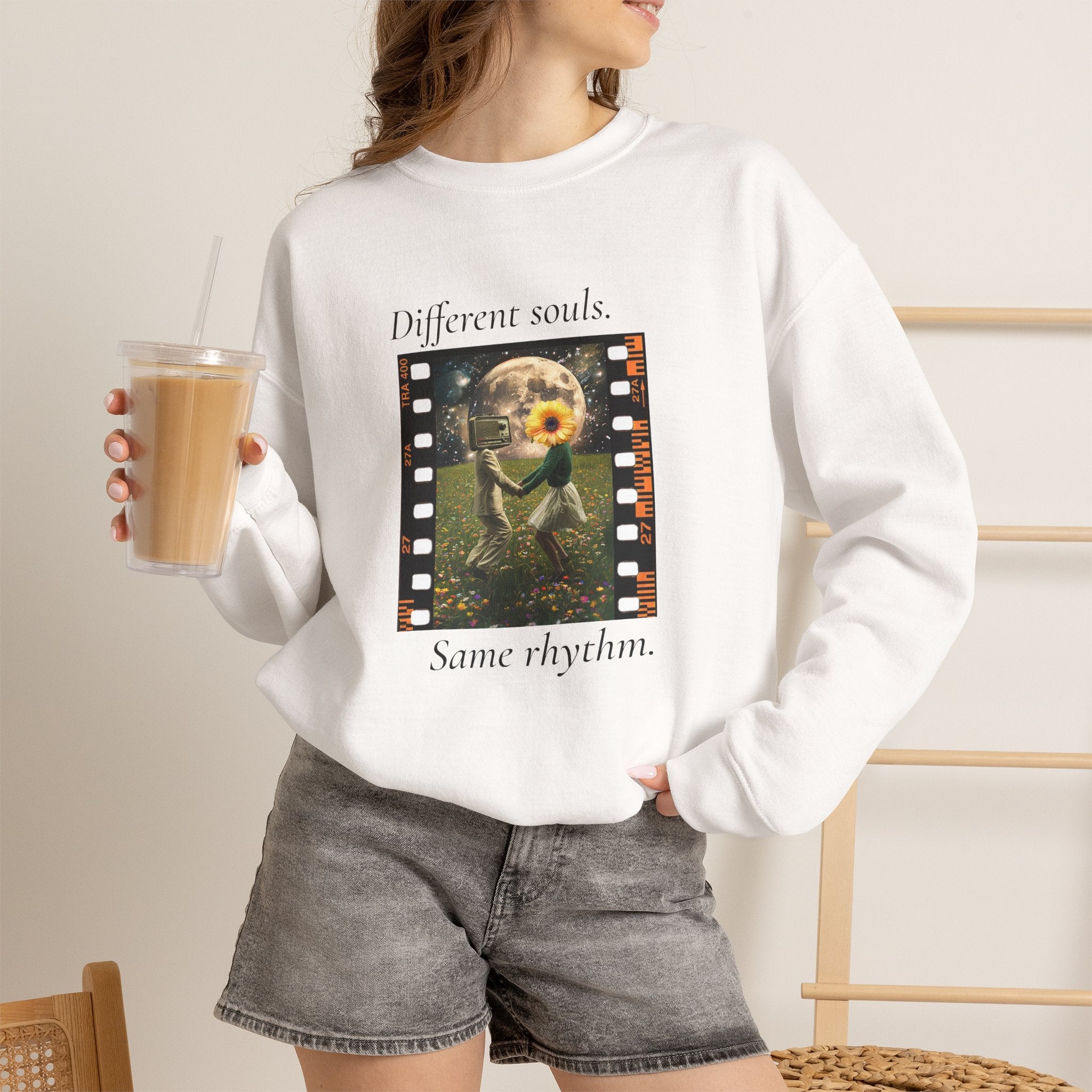 White crewneck sweatshirt with “Different souls.” and “Same rhythm.” graphic