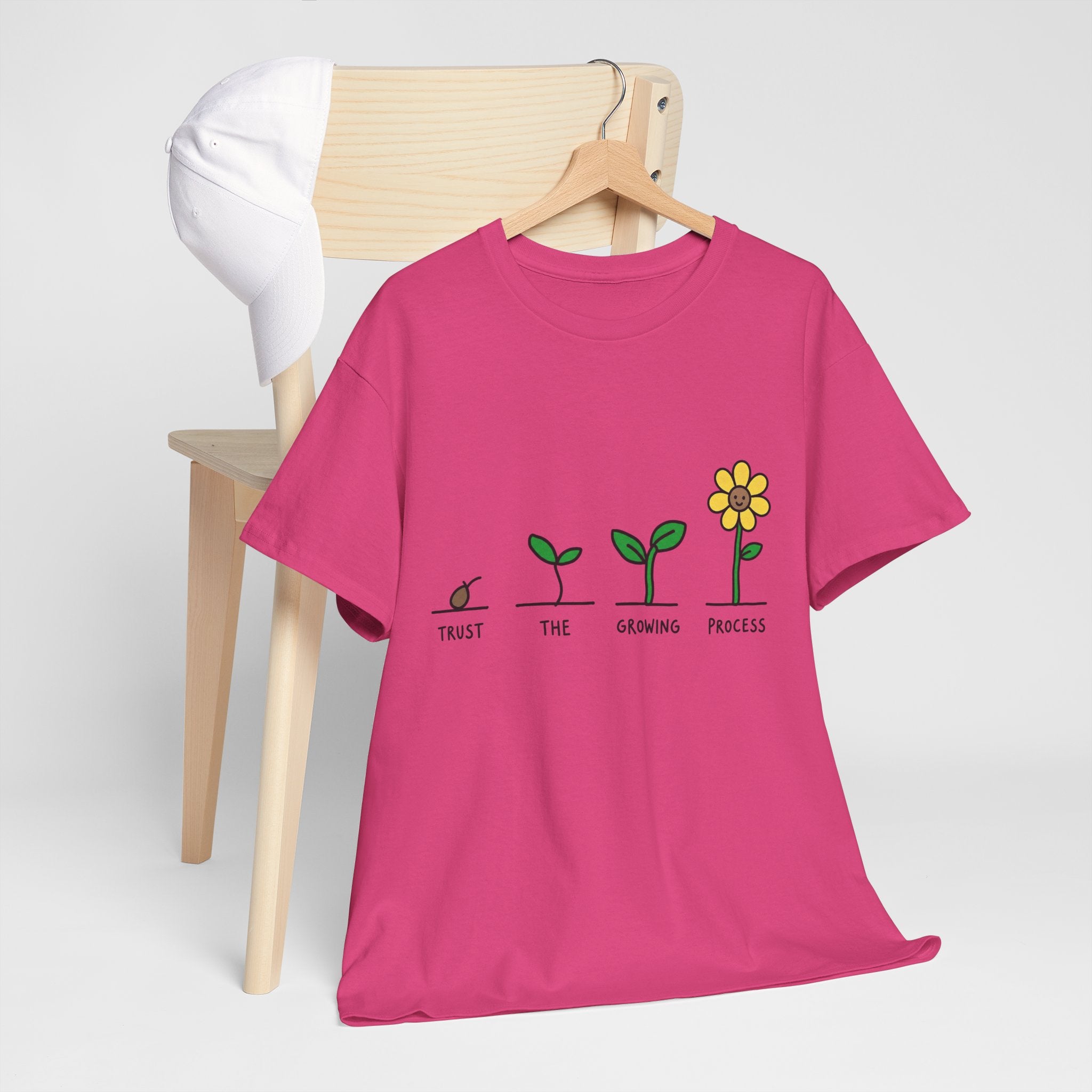 Pink crew-neck T-shirt with seedling-to-flower graphic and 'Trust the Growing Process' wording