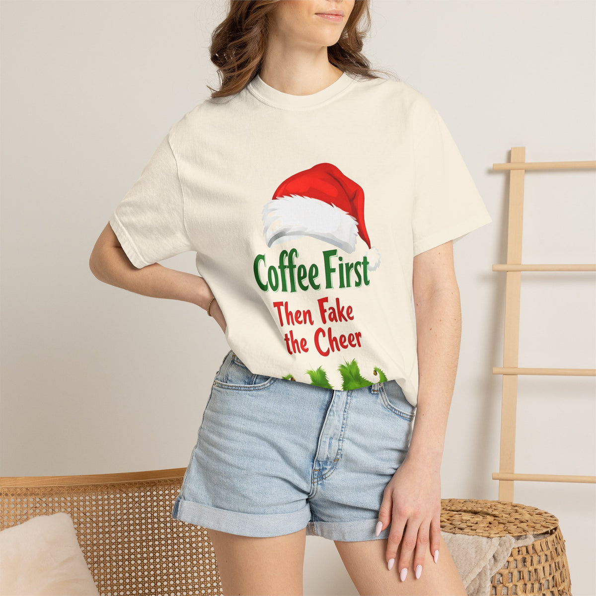 Ivory unisex Christmas T-shirt worn, featuring Santa hat 'Coffee First' and cheer slogan