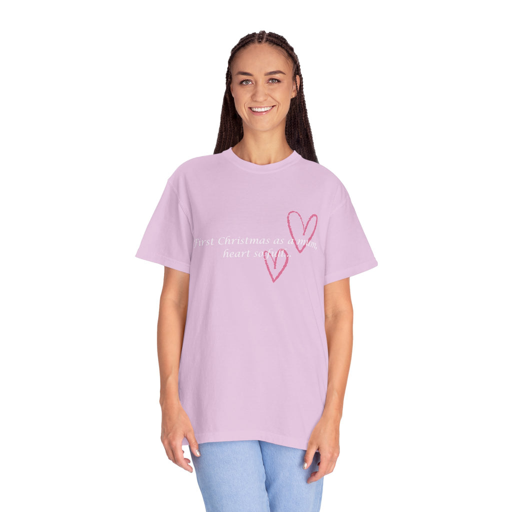 Light pink Christmas mum heart T-shirt on model with pink heart graphic and “First Christmas as a mum”