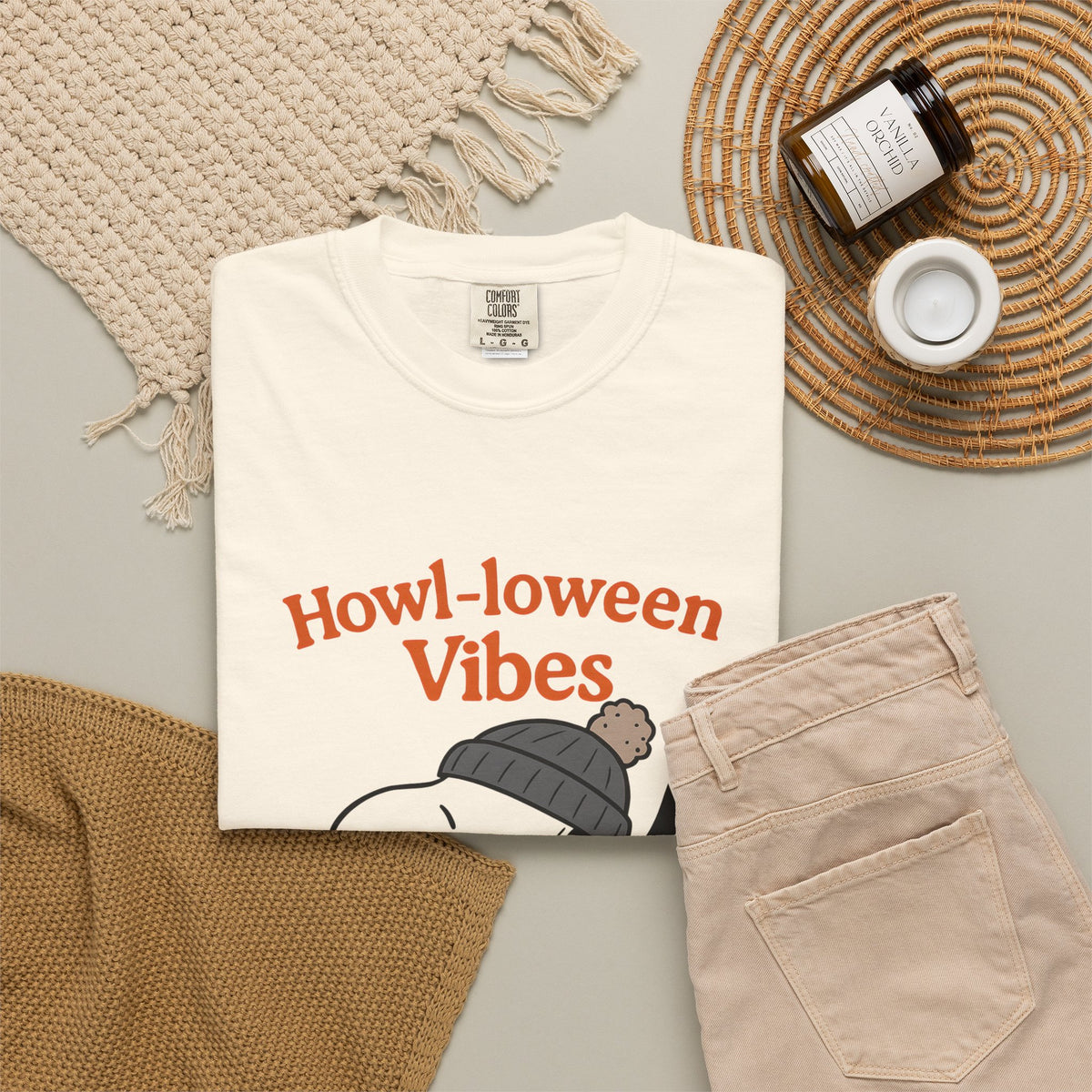 Ivory dog Halloween graphic t-shirt with “Howl-oween Vibes” front print