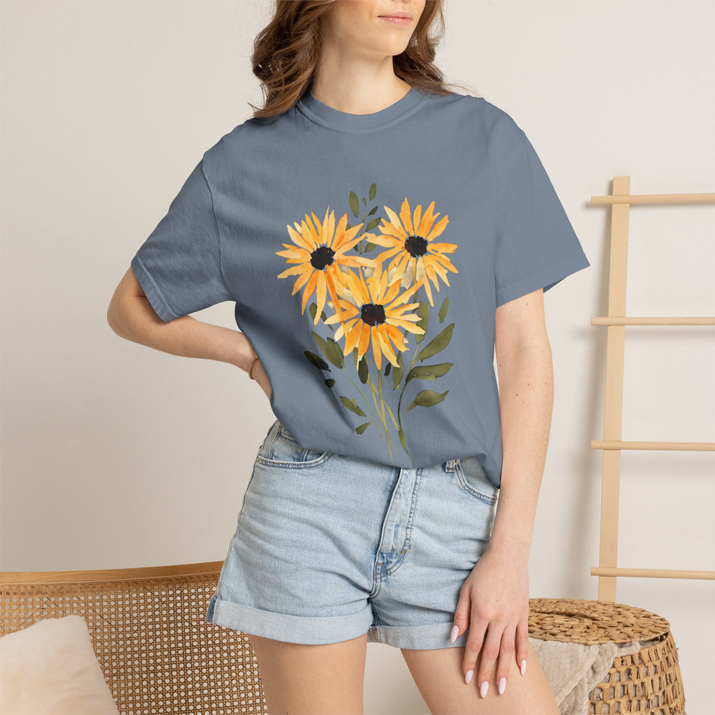 Blue crew-neck T-shirt with orange sunflower bouquet graphic, worn with light denim shorts