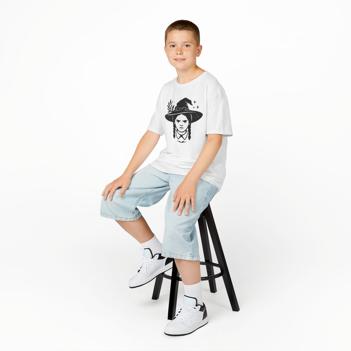 White kids unisex witch graphic T-shirt on a child, front print visible