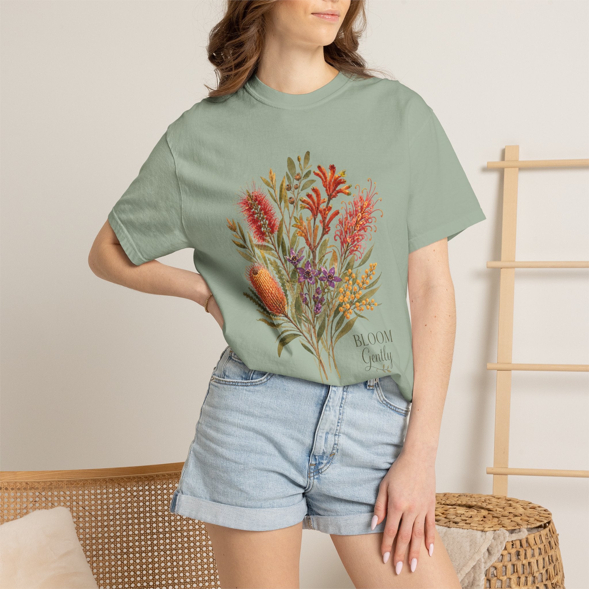 Sage green crew-neck T-shirt with botanical bouquet graphic in orange and purple
