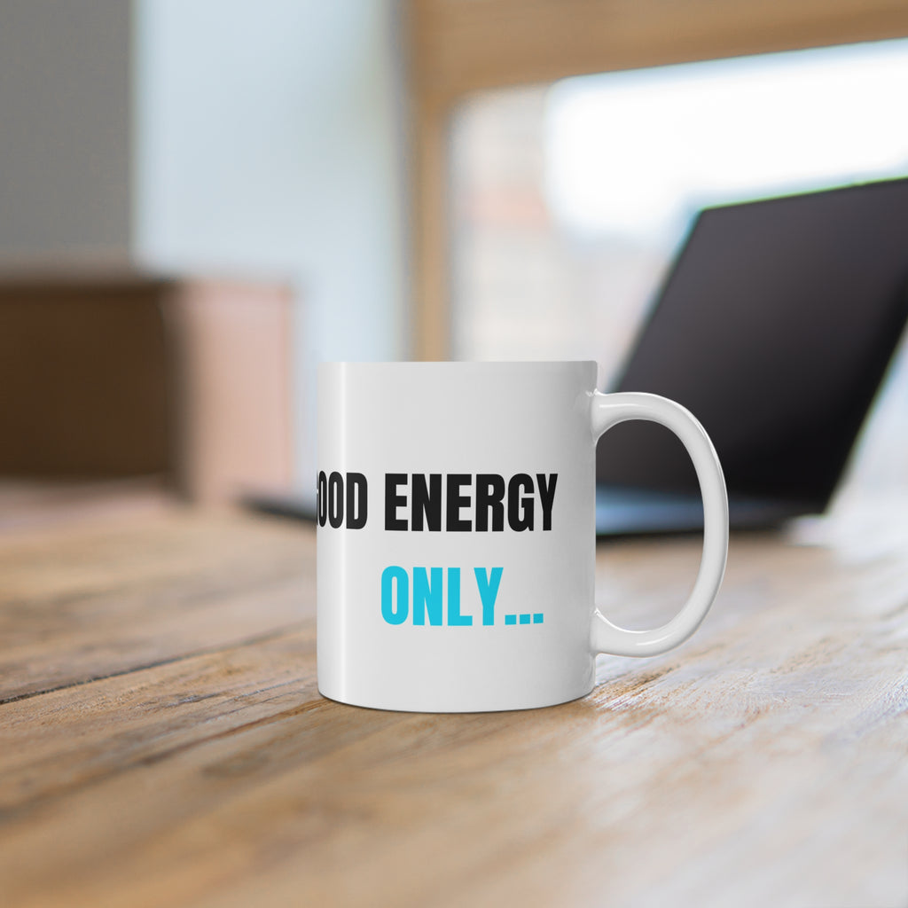 White ceramic mug with 'GOOD ENERGY ONLY...' print in black and blue and a handle.