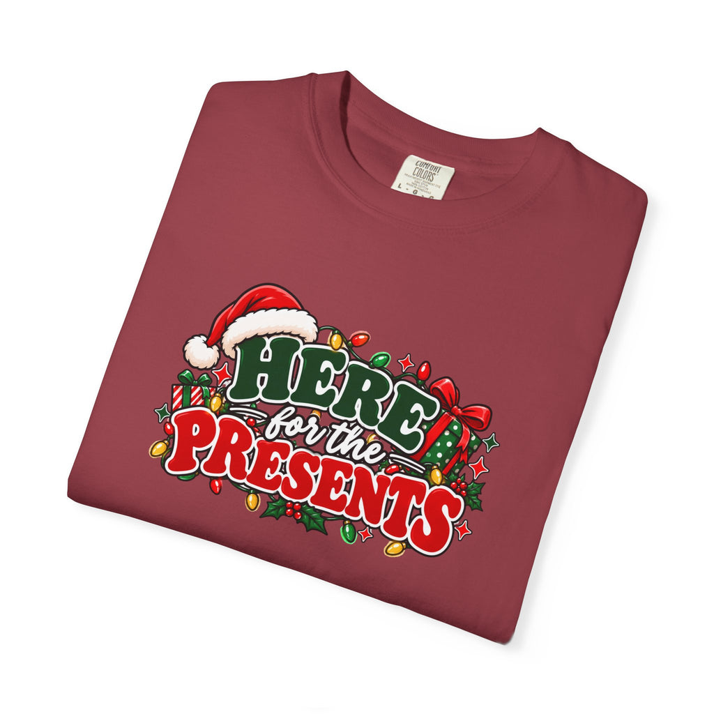 Red graphic Christmas T-shirt flat lay with “Here for the Presents” Santa wreath print