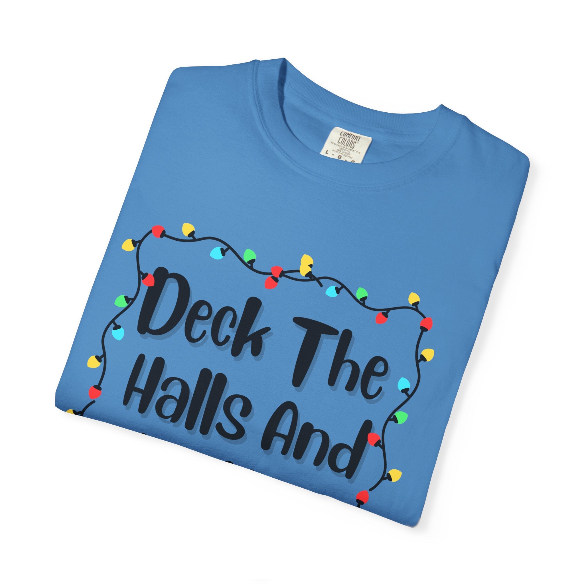 Blue crewneck T-shirt folded with holiday lights border and decorative text