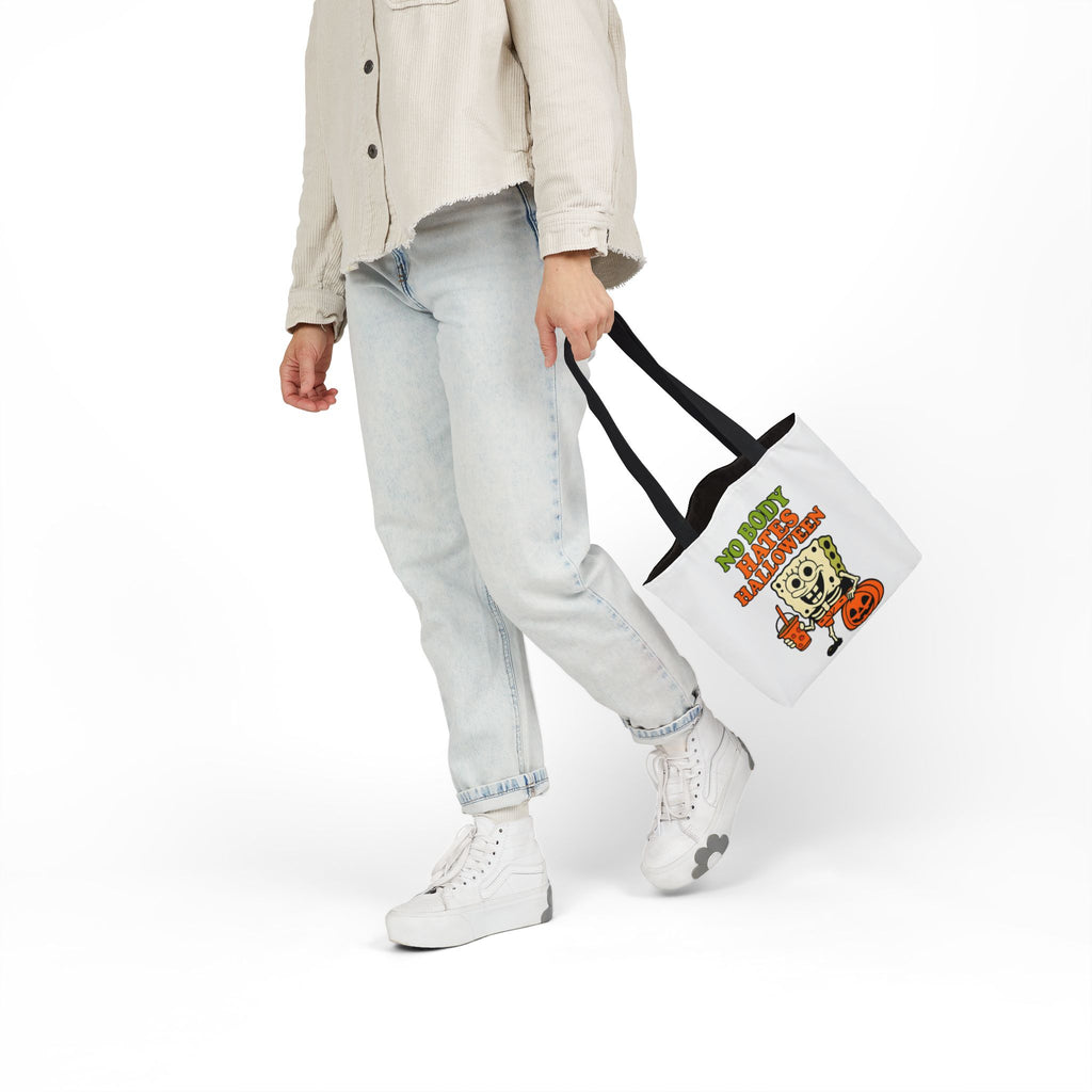 White canvas tote bag with black handles, Halloween cartoon print on the front