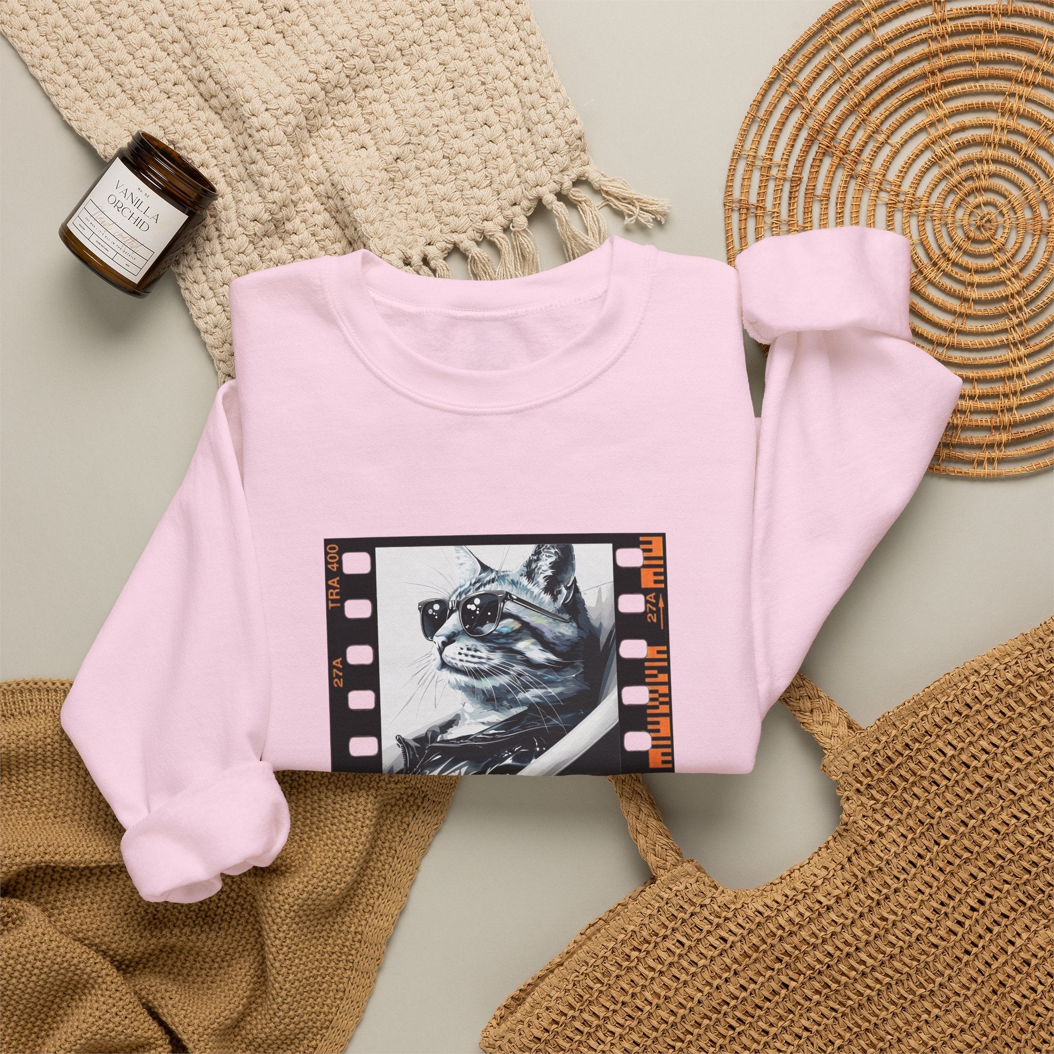 Light pink crewneck sweatshirt with centered cat graphic on front