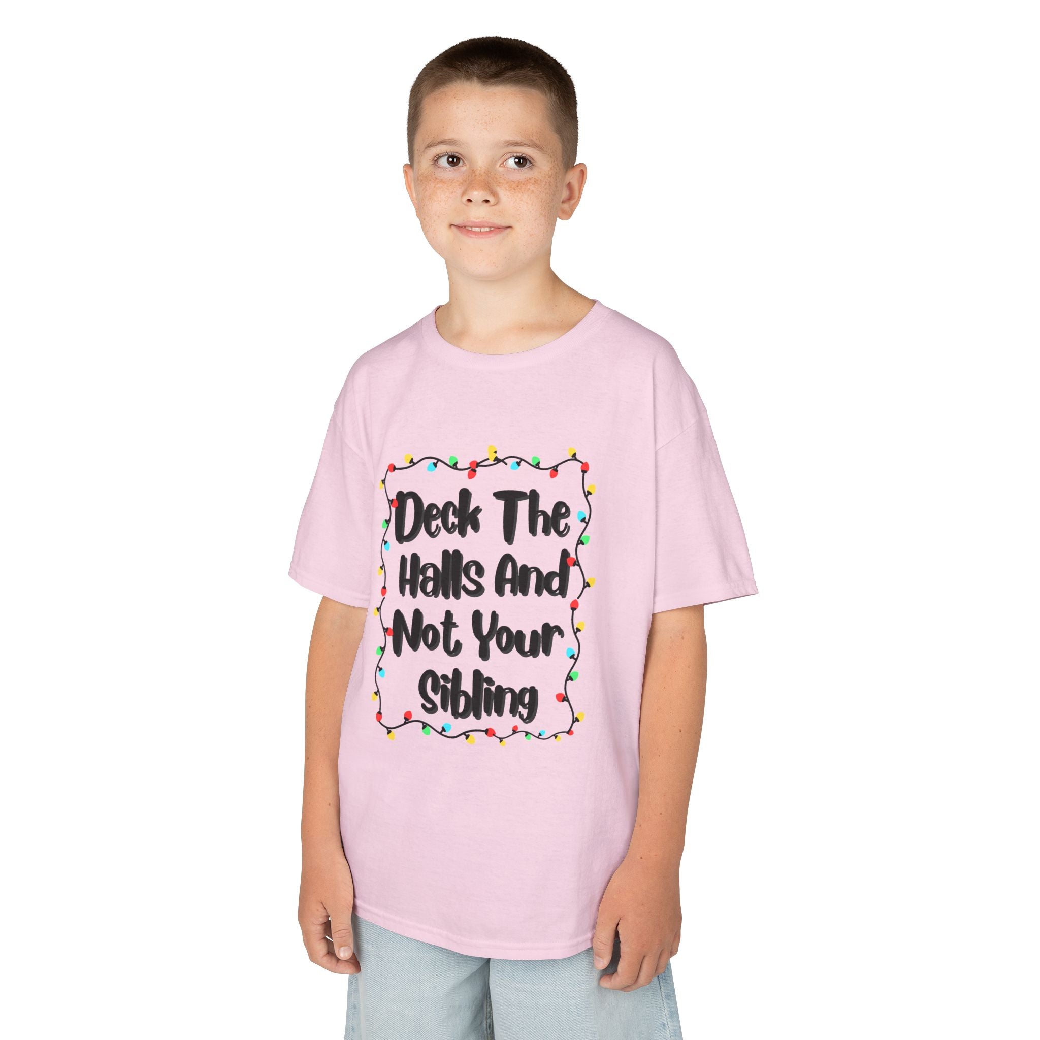 Light pink kids graphic tee on child, colorful holiday lights slogan design