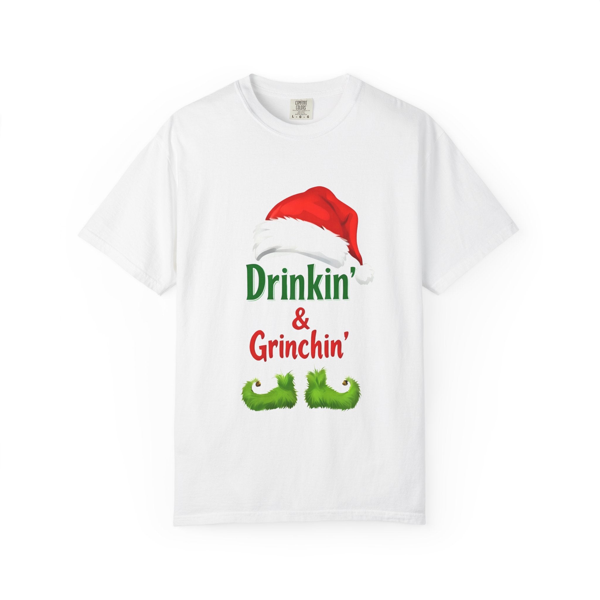 White graphic T-shirt featuring “Drinkin’ & Grinchin’” and a red Santa hat