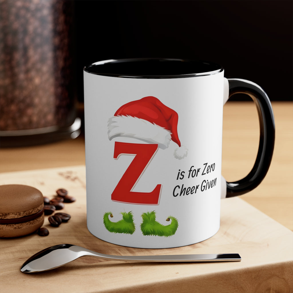 White mug with black handle; red Z, Santa hat, and 'is for Zero Cheer Given'