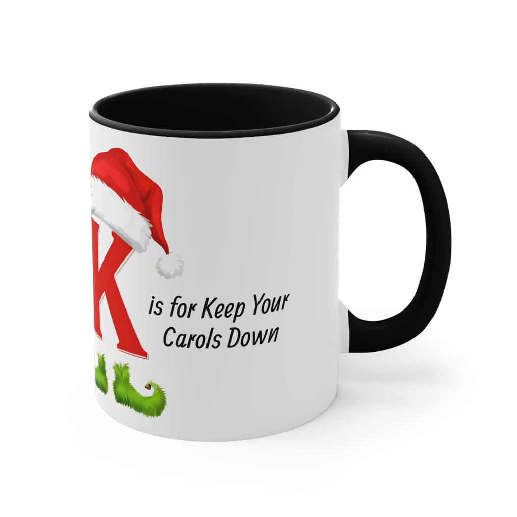 White mug with black handle, K letter and Keep Your Carols Down holiday text.
