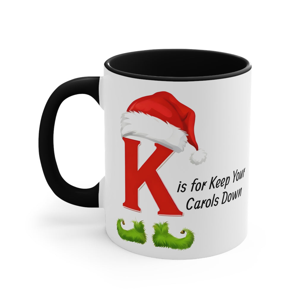 White ceramic mug with black handle and dark inside, large red K with Santa hat.