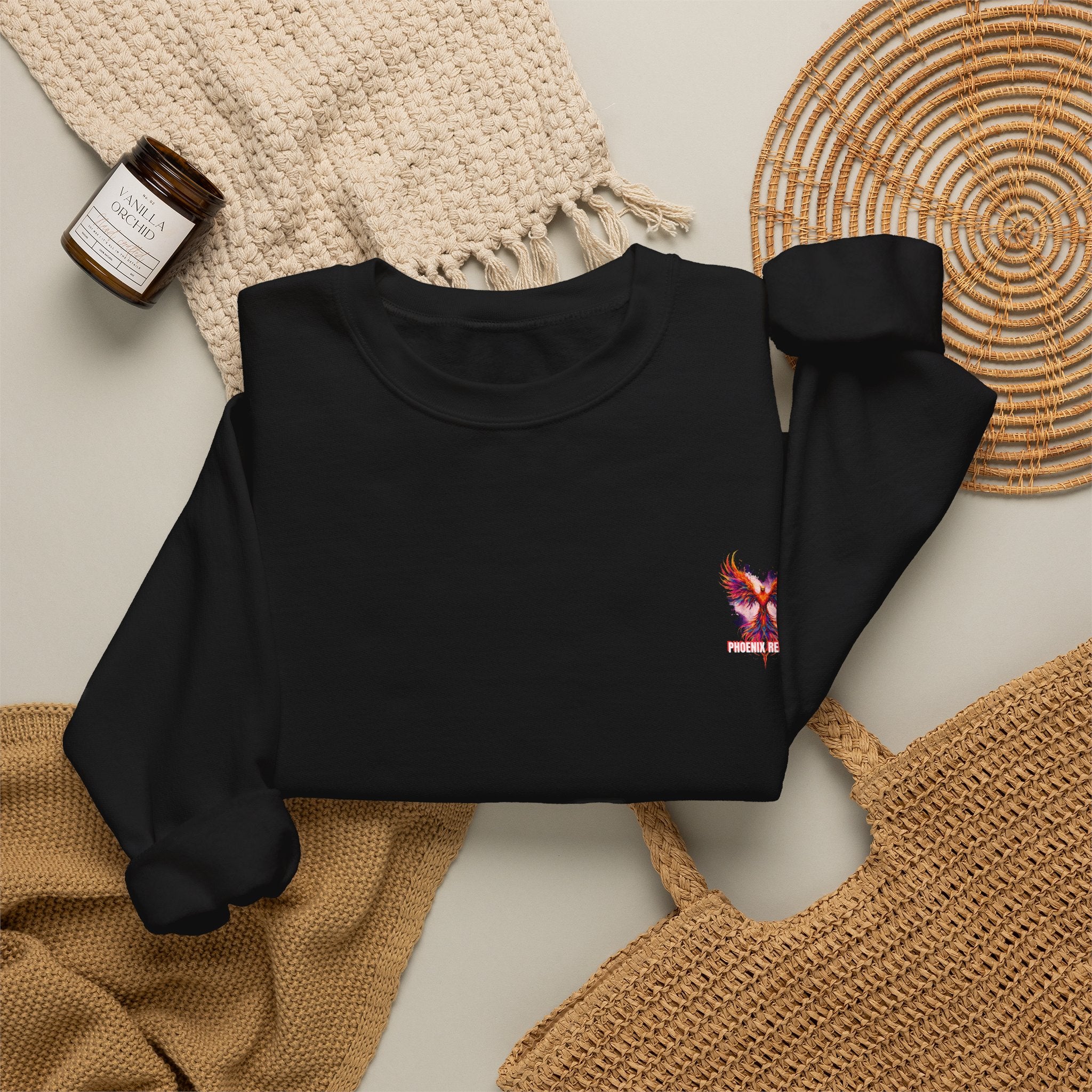 Black crewneck sweatshirt with small phoenix bird graphic and long sleeves