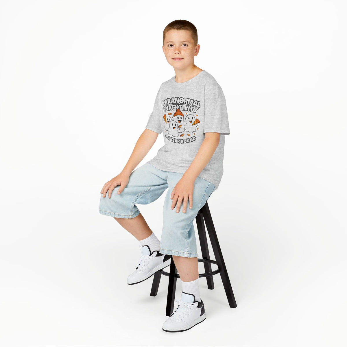 Kids ash gray T-shirt with cute ghost cartoon graphic, worn with denim shorts