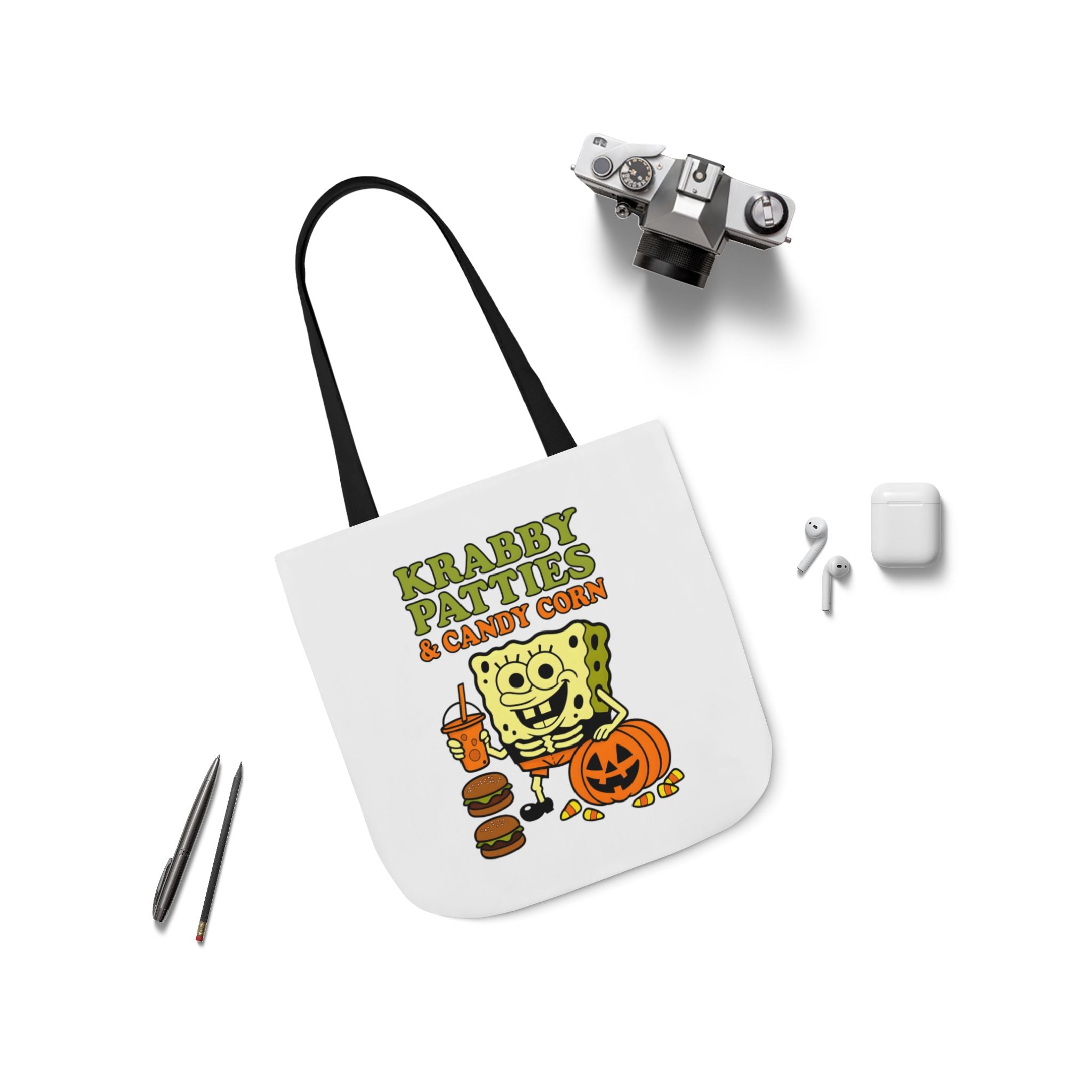 White canvas tote bag with black strap, featuring Krabby Patties & candy corn graphic