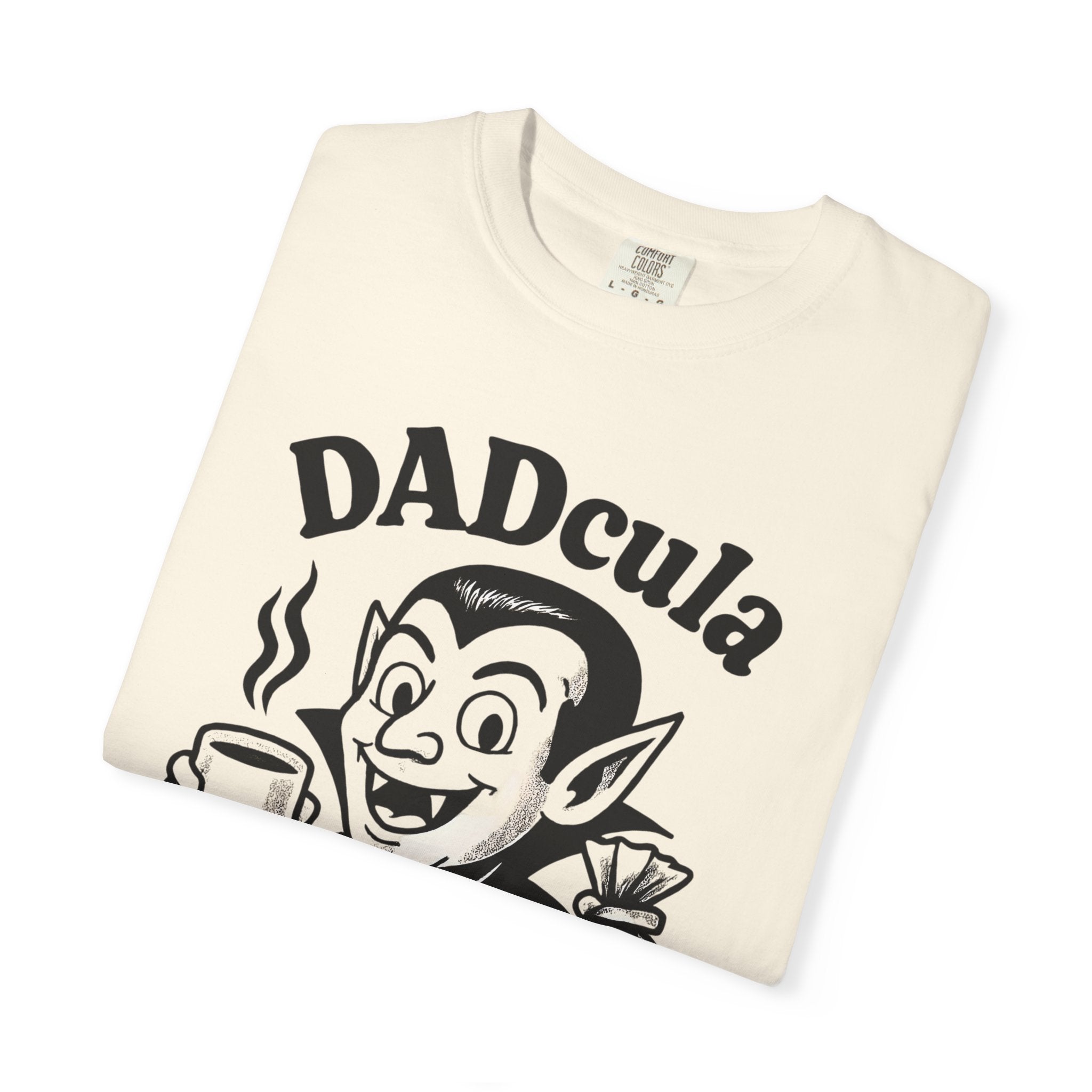 Ivory cotton T-shirt folded, showing black 'DADcula' character with coffee and lollies