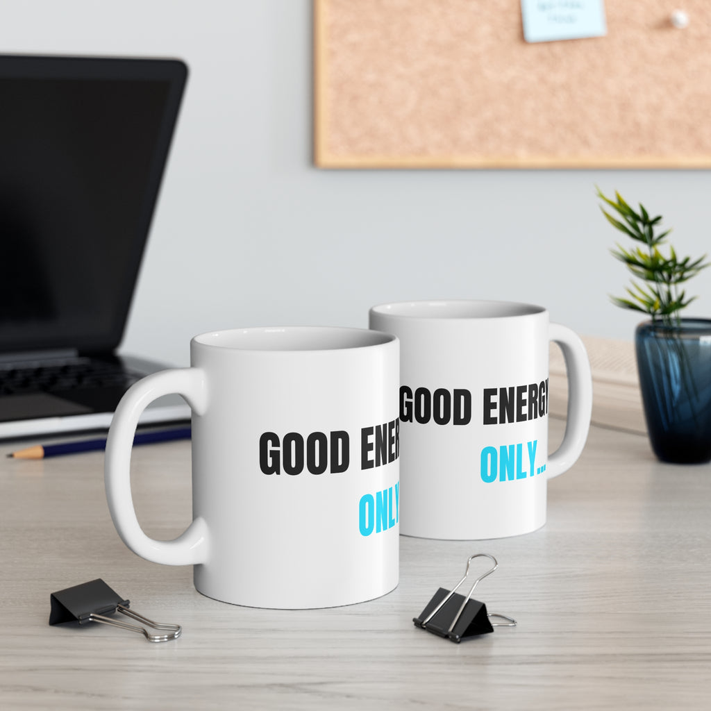 Set of two white ceramic mugs with 'GOOD ENERGY ONLY...' print in black and blue.